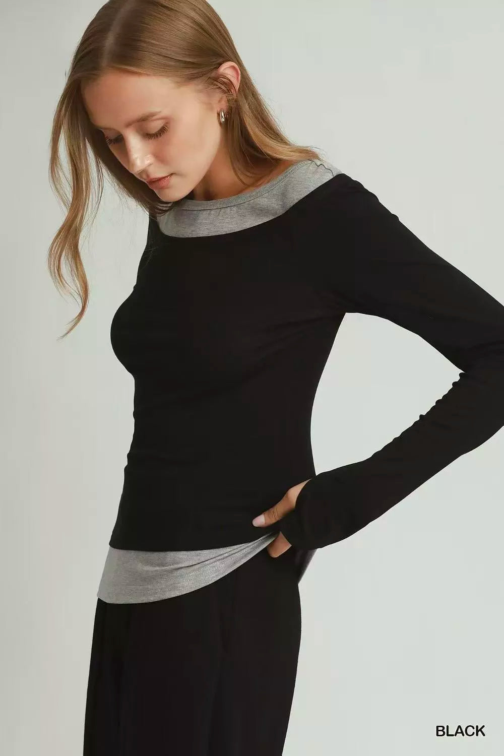 Close-up of thumbhole detail on layered twofer top