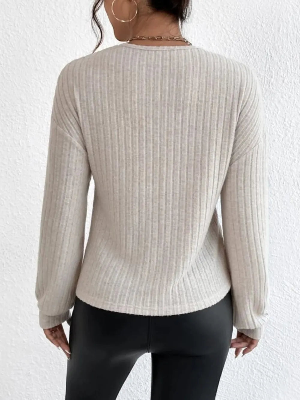 Close-up of surplice neckline detail on dropped shoulder top