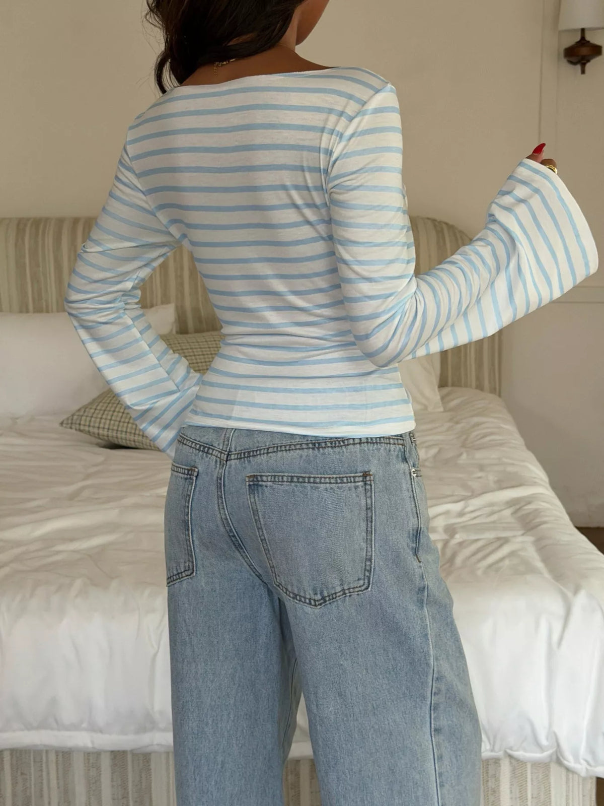 Model wearing light blue striped flare sleeve t-shirt, full outfit