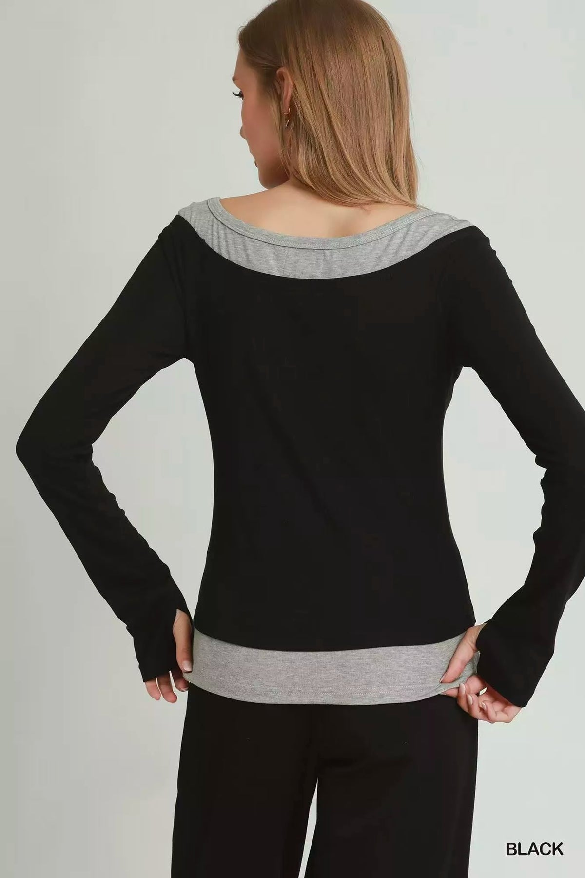 Side view of black layered twofer long sleeve top