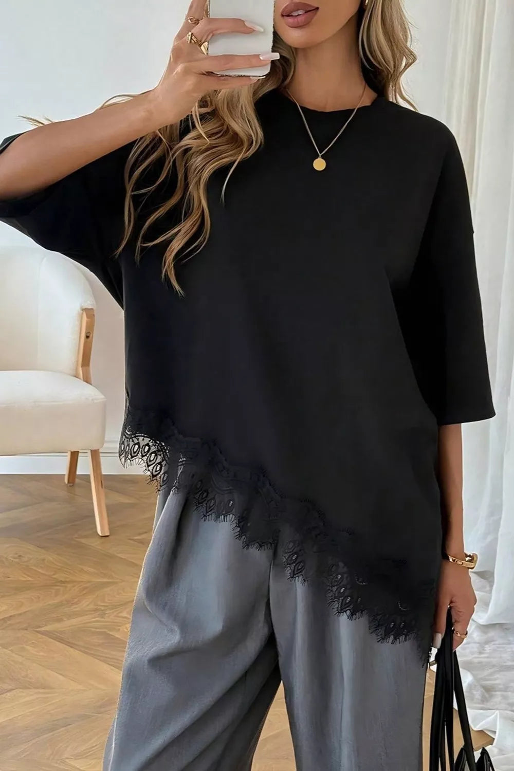 Close-up of lace trim detail on asymmetrical hem t-shirt