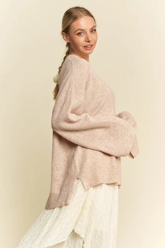 Oatmeal knit sweater with drop shoulder detail, styled with jeans